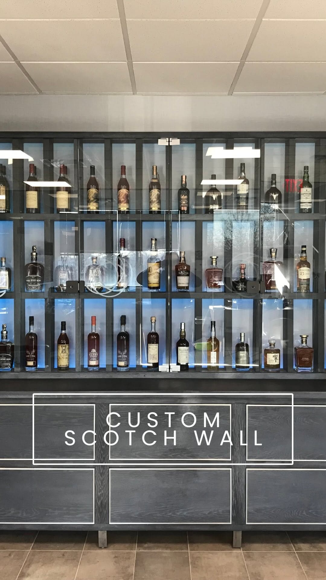 Custom scotch wall with automatic drawers